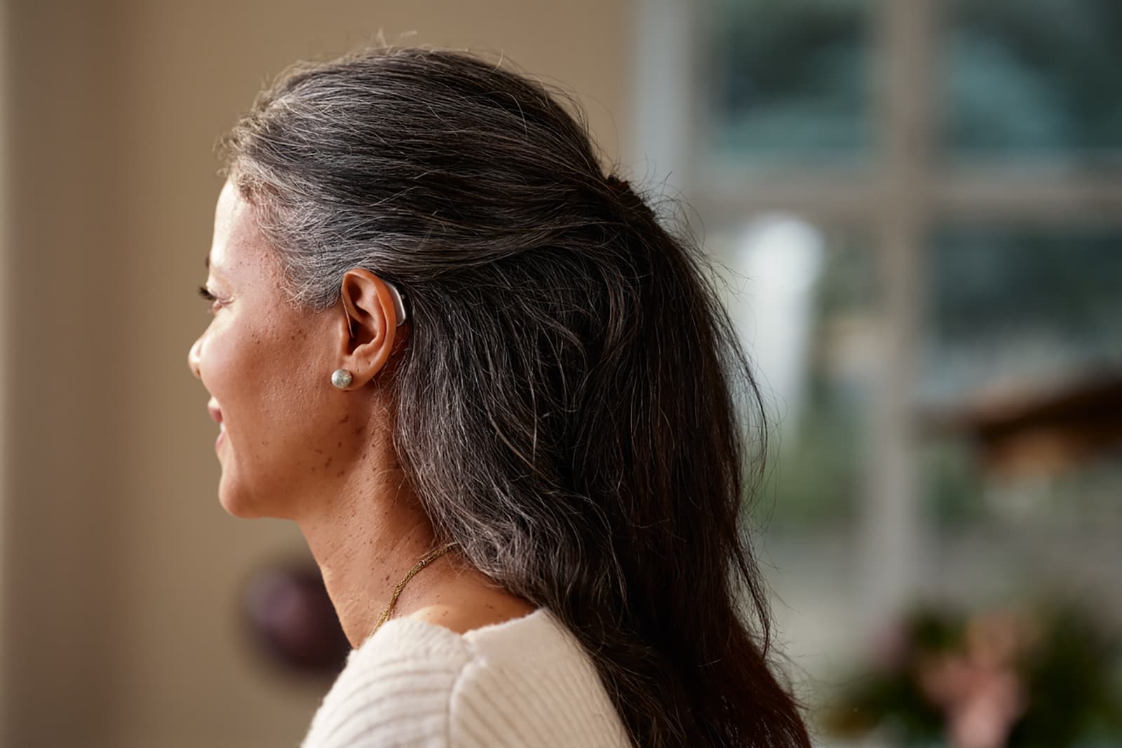 Woman wearing Widex Allure RIC hearing aids