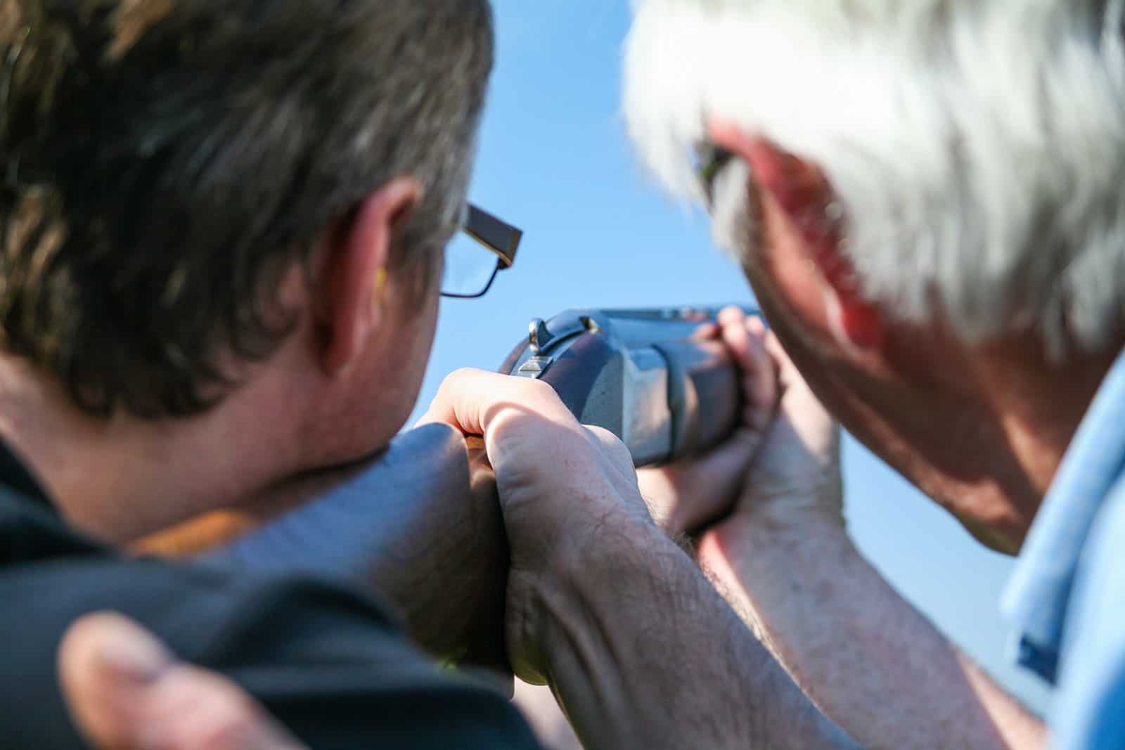 Two men using firearms