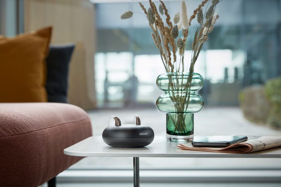 hearing aids in charger on coffee table