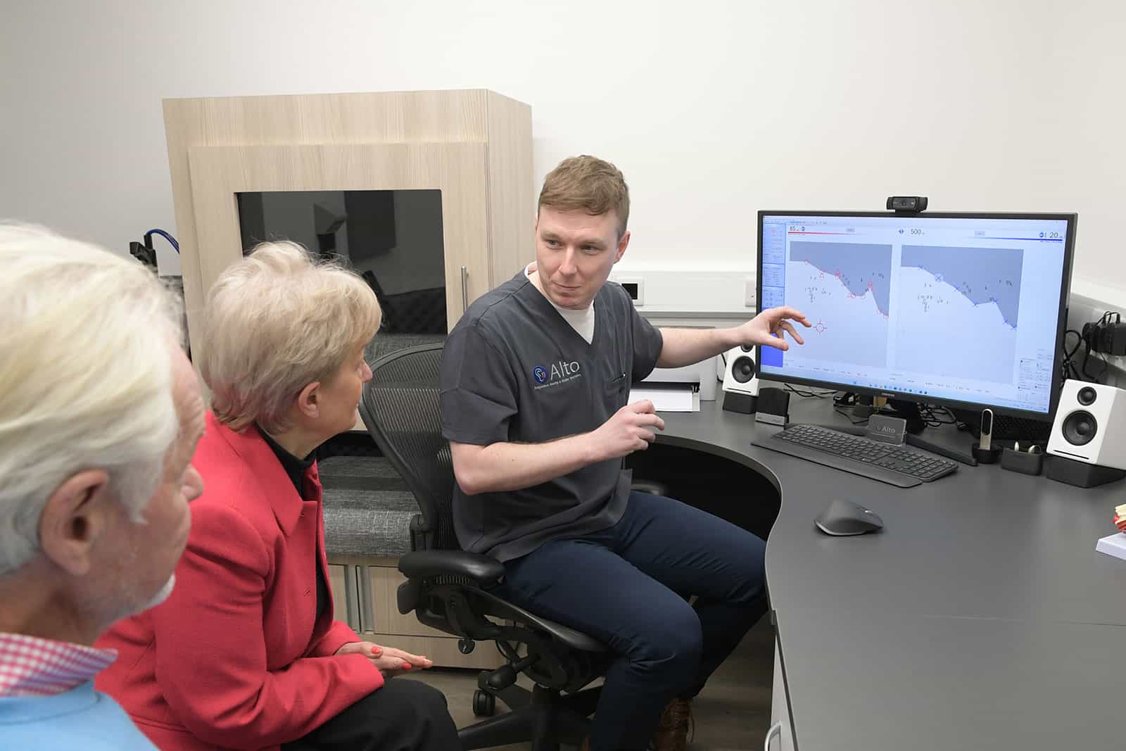 Audiologist explaining hearing test results to a couple