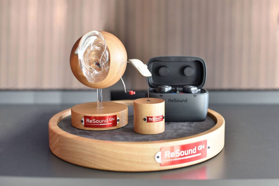 Display stand showing Resound Omnia RITE and Custom Rechargeable Hearing Aids