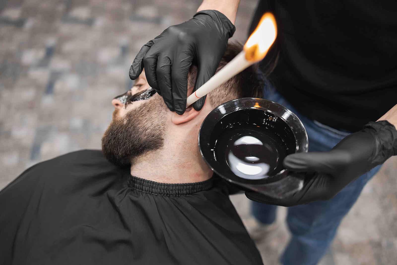 Man receiving ear candle treatment